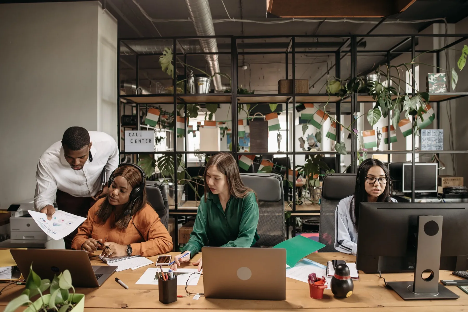 Contact centre agents working at their desks in a modern office
