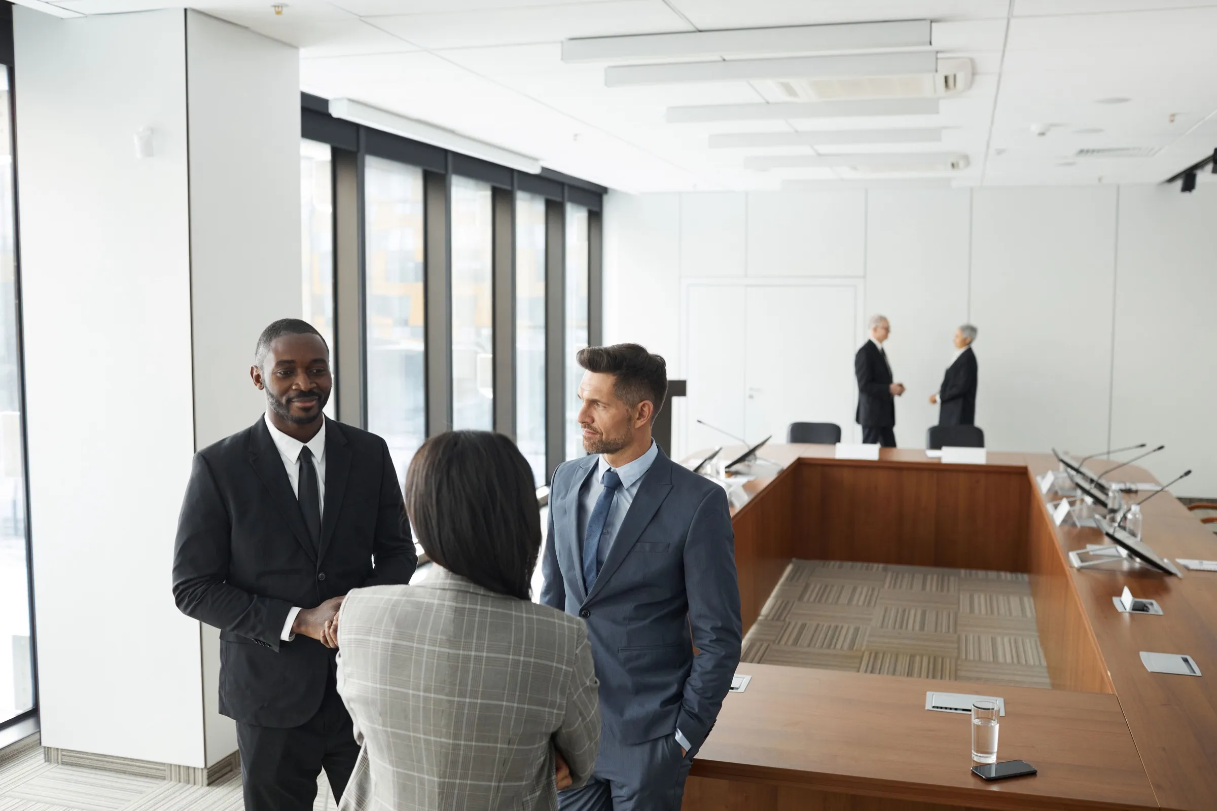 Two consultants in conversation in a modern boardroom