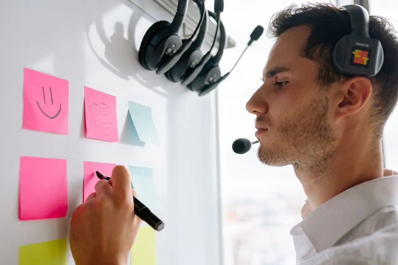 Contact centre agent planning on a wall of sticky notes